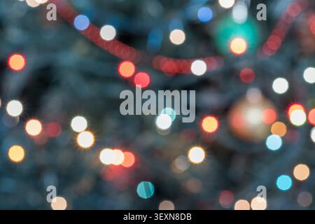 Extreme close-up abstract festive background with warm glowing Christmas lights creating a rich bokeh effect. The composition features soft golden, re Stock Photo