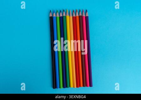 Colored pencils on blue background. Back to school concept. Stock Photo