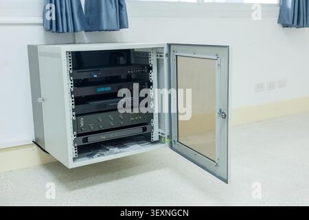 A server rack network equipment metal cabinet open door technology data center communication electronic device wall mounted cable management modern se Stock Photo