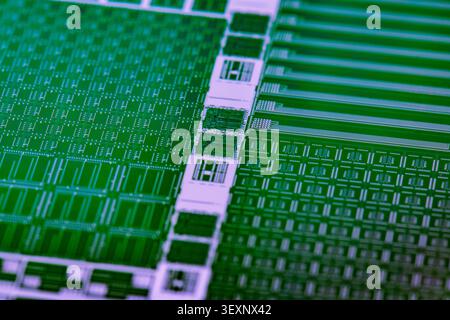 Silicon wafer displaying intricate patterns of integrated circuits and semiconductor microchips Stock Photo