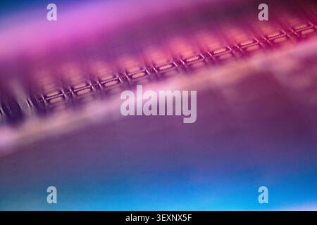 Microscopic view of a shiny wafer surface with intricate circuit patterns Stock Photo