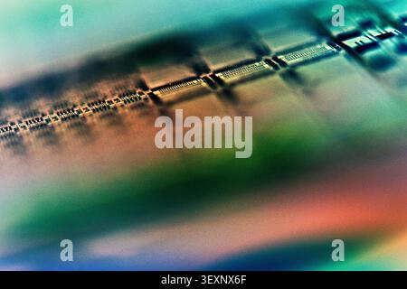 Wafer surface displaying microchip components and electronic circuits in a blurred abstract composition Stock Photo