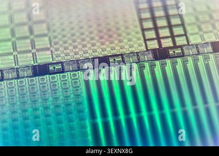 Silicon wafer displaying intricate electronic chip patterns with a reflective surface Stock Photo