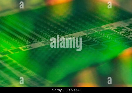 Macro view of a silicon wafer displaying integrated microchip circuits and abstract patterns Stock Photo