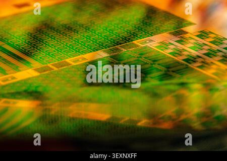 Wafer showing microelectronic circuit patterns creating an abstract, futuristic background Stock Photo