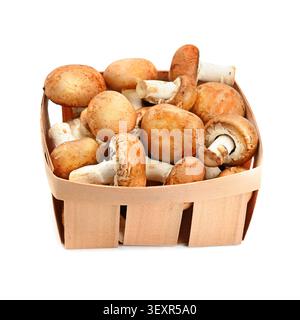 Fresh champignons in a wicker basket isolated on a white background. Stock Photo