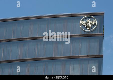 he golden bee logo on the modern glass facade of Erste Group Bank AGs headquarters (Erste Campus) in Vienna. Stock Photo