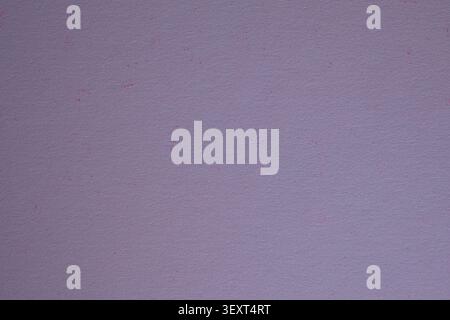 Close-up of lavender purple textured paper with subtle pink speckles and a smooth matte finish. Soft pastel paper background with fine texture. Stock Photo