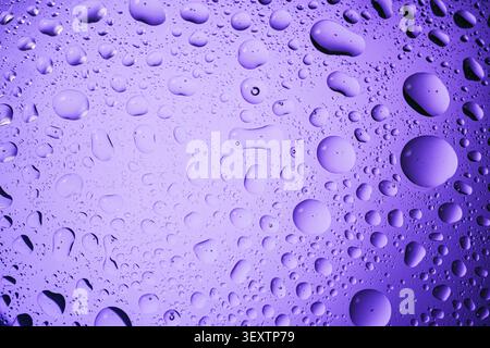Water drops of various sizes creating an abstract background texture Stock Photo