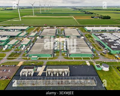 Middenmeer, Netherlands - June 15, 2026: Sustainable data center campus in Middenmeer, Netherlands, multiple large buildings and a row of wind turbine Stock Photo