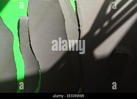 Gray torn paper overlapping on green screen with natural shadow overlay creating abstract texture Stock Photo