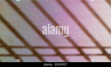 Digital screen close-up showing individual pixels and shadowy straight lines on a colorful background Stock Photo