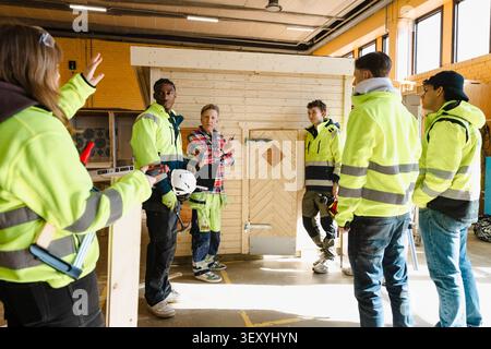 Carpentry workshop being held by senior male teacher for students in upper secondary vocational workshop Stock Photo