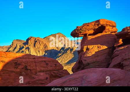 Red Rock Formations and Desert Mountains at Sunset in Valley of Fire Nevada Stock Photo