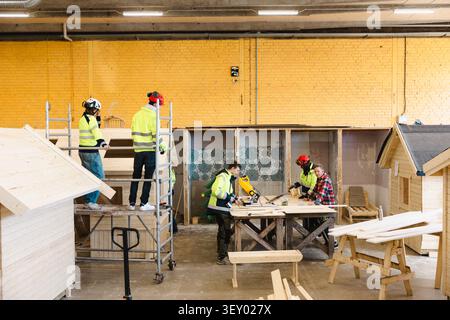 Vocational students doing carpentry tasks in workshop at upper secondary school Stock Photo
