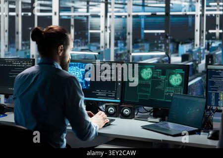 Engineer uses AI tools in a data center to manage global server infrastructure and international networks. Stock Photo