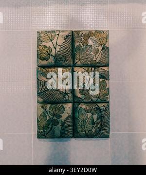 Decorative ceramic tile artwork with botanical leaf patterns. Stock Photo