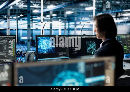 Data center programmer manages databases supporting AI applications and data mining in a server facility. Stock Photo