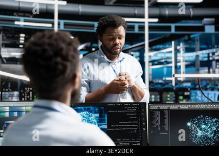 Software developers cooperate in a server farm, using machine learning algorithms to analyze datasets and recognize data patterns. Stock Photo