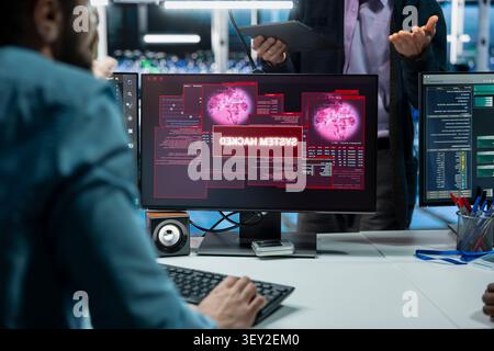 Programming team members improve security systems in a server farm with machine learning to help prevent breaches. Stock Photo