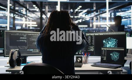 Engineer reacts with frustration in a server farm as node tree systems fail to categorize unstructured data. Stock Photo