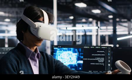 Programmer uses a VR headset to review AI diagnostics and manage server system performance. Stock Photo