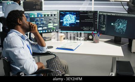 Impatient technical specialist with paraplegia in high tech server room annoyed by slow AI visual programming system with upset computing hub staff member with disability frustrated by buggy visual. Stock Photo