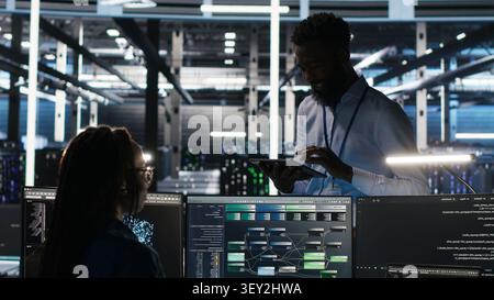 Data center manager uses node tree AI software to analyze infrastructure and identify issues in a data center. Stock Photo