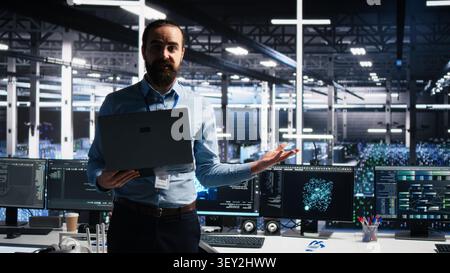 Data infrastructure center team supervisor showcasing AI technology, filming presentation video for audiences, while team leader presenting AI machine learning tech. Stock Photo
