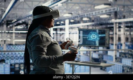 IT specialist uses virtual reality in a data center to adjust AI configurations and improve processing speed. Stock Photo