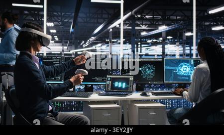Computing facility technical specialist working with virtual reality, managing AI systems for uptime. Stock Photo