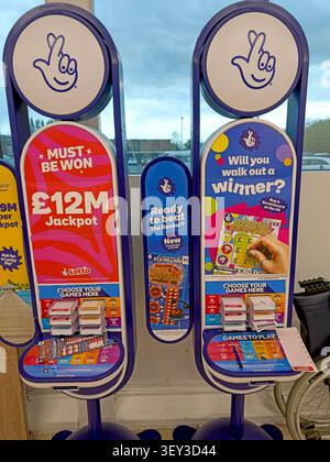 National Lottery promotional stands advertising a £12m jackpot in a UK retail outlet. Stock Photo