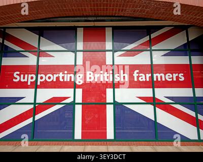 Morrisons Union Flag window advert with the slogan “Supporting British farmers” at its Warrington store near Stockton Heath Stock Photo