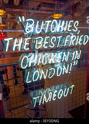 Neon Butchies sign promoting “The Best Fried Chicken in London” at the Bond Street restaurant near Ealing Broadway, west London Stock Photo