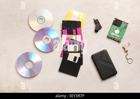Various data storage devices on a beige surface Stock Photo