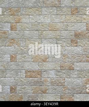 Close up of a rectangular rock and mortar wall surface with uniform block sized sawn stones in horizontal rows Stock Photo