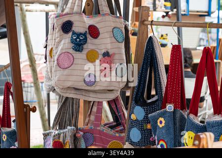 Chiang Mai, Thailand - 27 May 2026 : Handmade fabric tote bag with pink cat applique and polka dot pattern Stock Photo