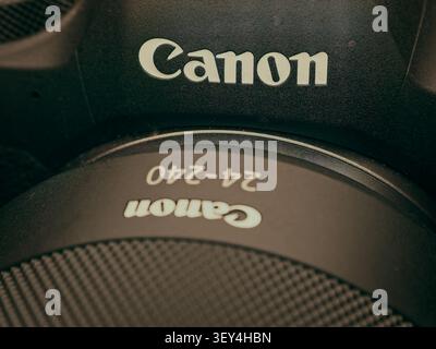 Macro close up view of a Canon camera body logo and matching lens barrel markings with focal length numbers Stock Photo