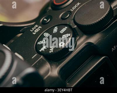 Macro close up view of a digital mirrorless camera top mode dial showing custom video settings and controls Stock Photo