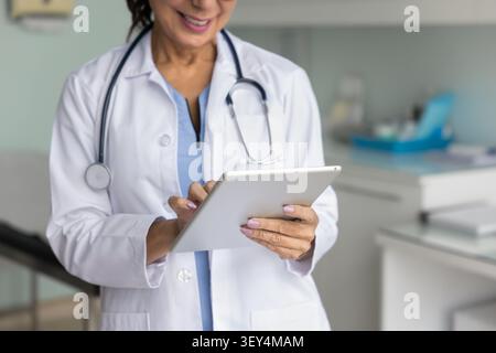 Cropped shot of happy mature doctor woman in white coat Stock Photo