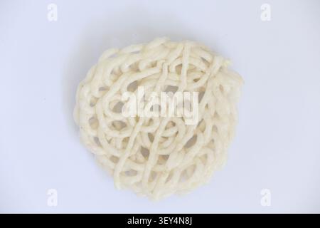Round Indonesian Cracker with Net Pattern Isolated on White Background Stock Photo