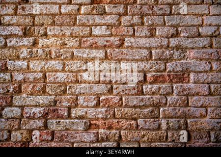 Old worn faded brick wall background texture Stock Photo