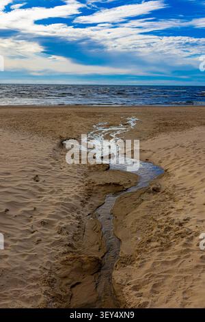 A wide-angle landscape features a winding river flowing through a lush ...