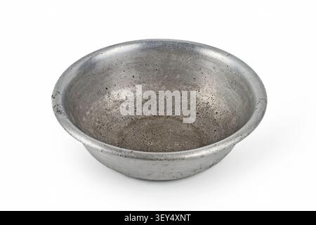 Antique aluminum plate on a white background. Old aluminum bowl. Stock Photo
