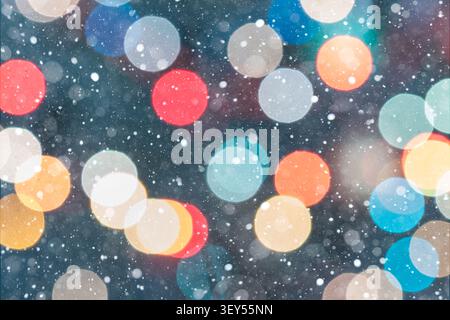 Horizontal festive background featuring multicolored bokeh lights in red, yellow, green, orange, blue, and white against a dark green background. Fall Stock Photo