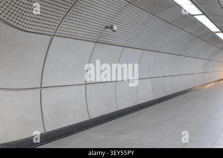 Curved concrete panel wall in an underground station Stock Photo