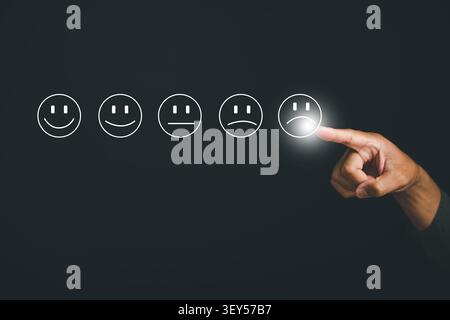 Customer experience dissatisfaction concept. Unhappy man giving a sad expression on an online survey. Dislike, bad service quality, and low rating aff Stock Photo