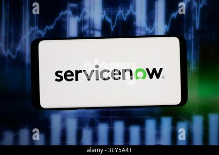 In this photo illustration, the logo of US software company ServiceNow Inc. is displayed on a smartphone in front of abstract background on computer screen. Stock Photo