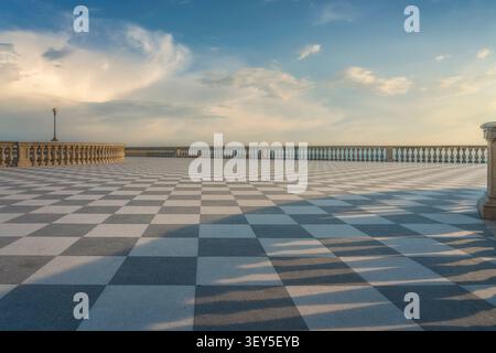 View of the historic Terrazza Mascagni with its iconic black and white checkerboard pavement and stone balustrade at sunset. Livorno, Tuscany, Italy Stock Photo