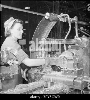 A Merlin Is Made- the Production of Merlin Engines at a Rolls Royce Factory, 1942 Mary Gordon operates a No 7 Ward combination lathe, producing sealing rings for the cylinder at this aircraft engine factory, somewhere in Britain. This is precision work, as an error of 0.001" would lead to the seizing up of the entire engine. Mary was a textile finisher before the war and her brother, a Commando, has been taken prisoner by the Italians. Stock Photo